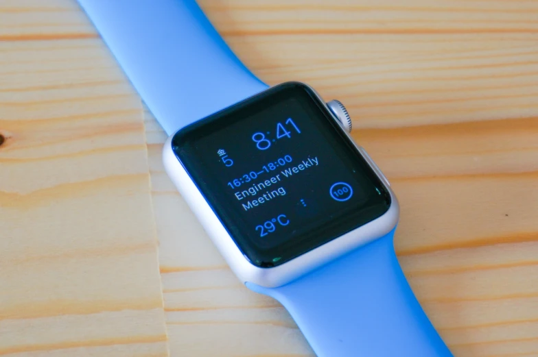 a close up of an apple watch on top of a wood table