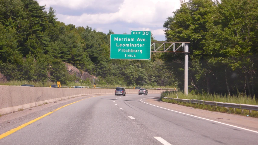 cars are traveling down a highway during the day