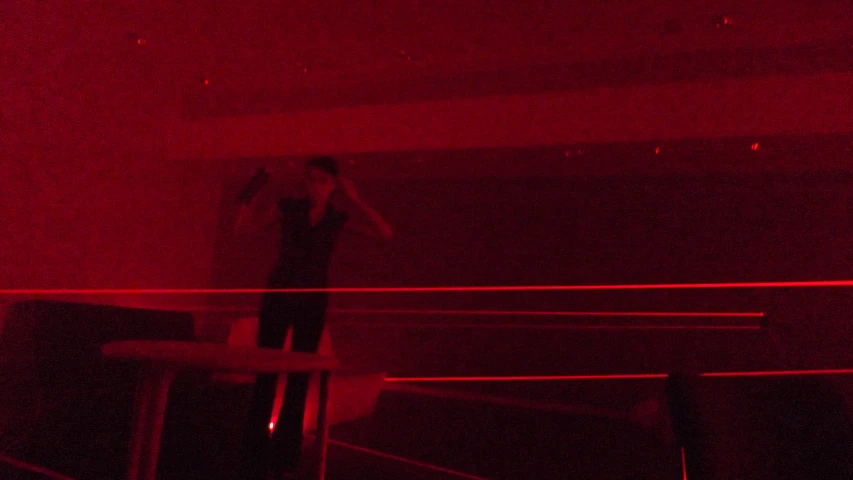 person in room with red lights taking selfie