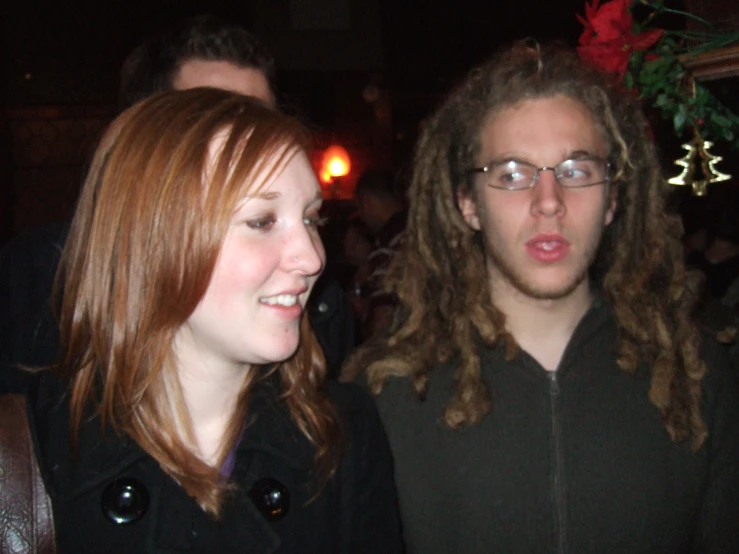 a man and woman talking and smiling at an event