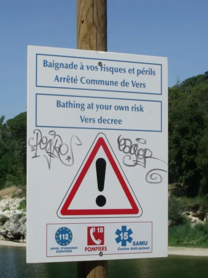 a sign at a lake warning people to not swim