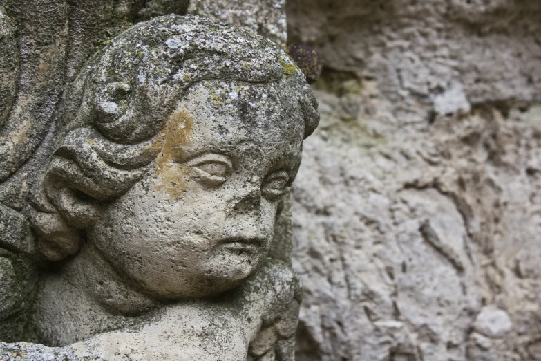 close up of the face of an old statue