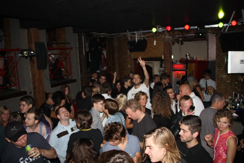 a large group of people standing in front of a bar