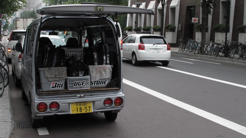 a van with two chairs in the back is parked on the street