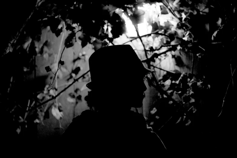 black and white image of a man holding an umbrella