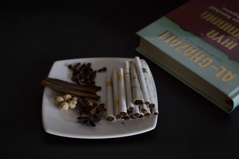 a plate filled with chocolate, nuts and cigarettes