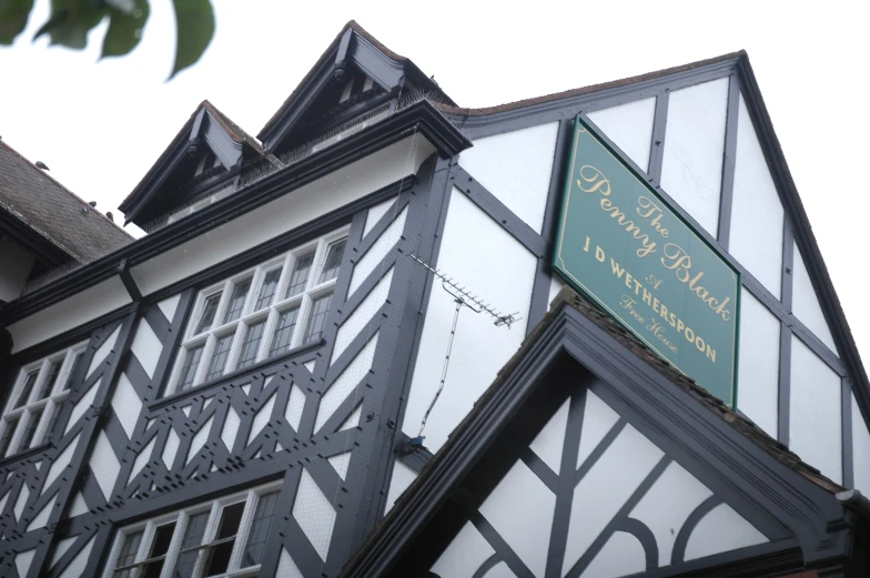 a building with a clock and some signs on the side