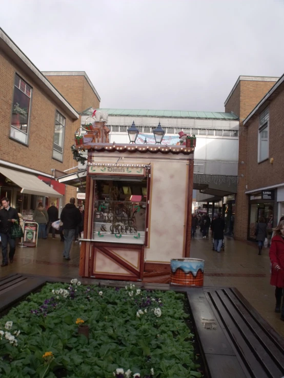 the old fashioned shops are being used as flower boxes