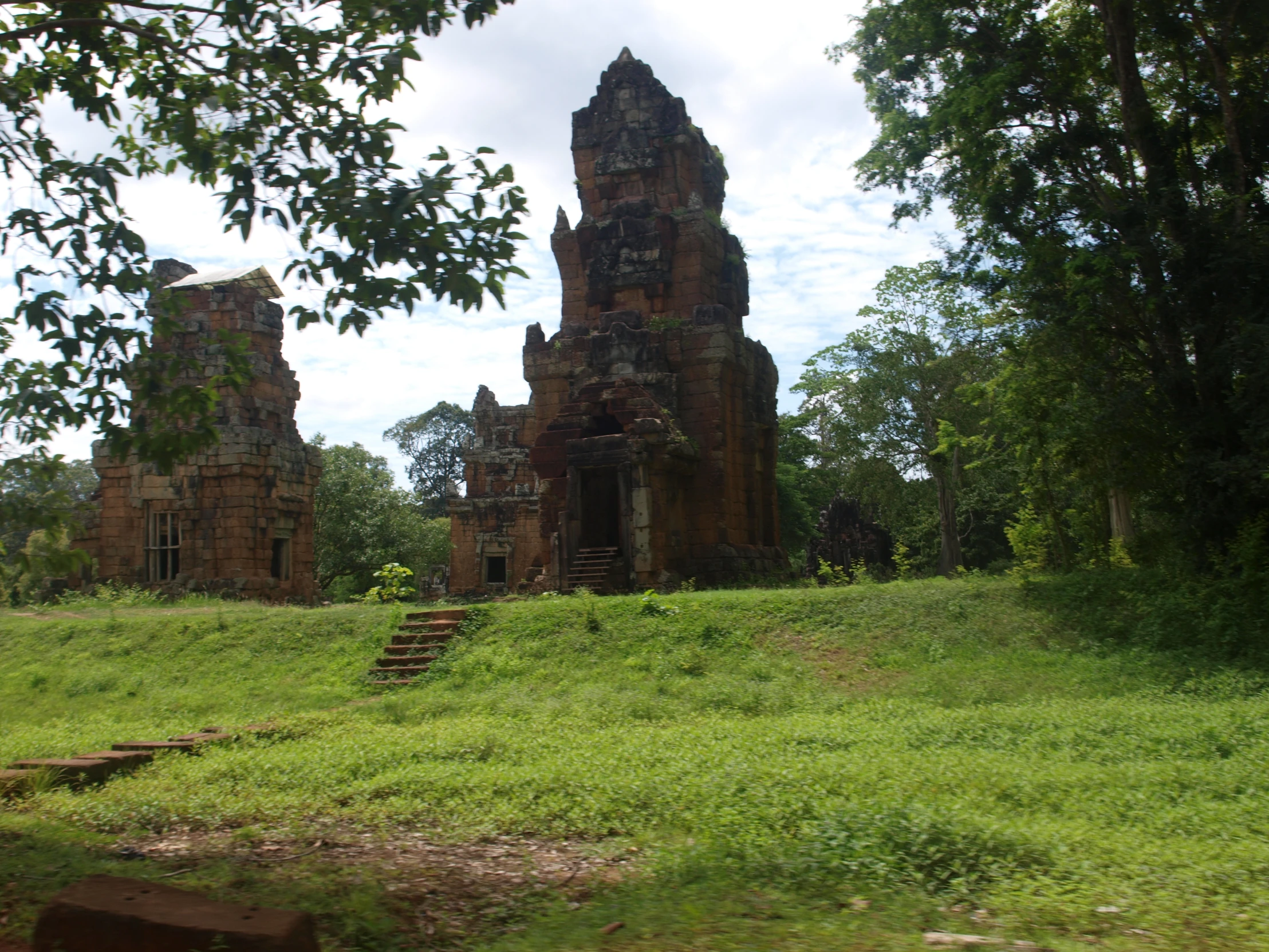 old ruins surrounded by trees on a hillside