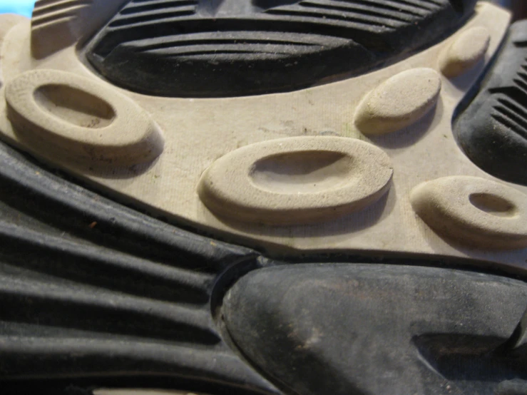 the top part of a tennis shoe with holes in it