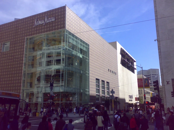 an intersection with a busy building near many pedestrians