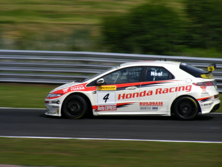 a car racing around a track on grass