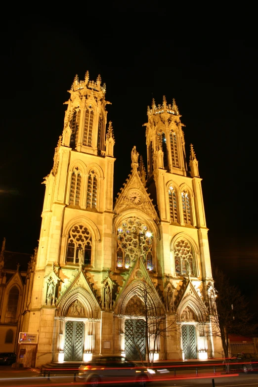 a big church with tall towers at night