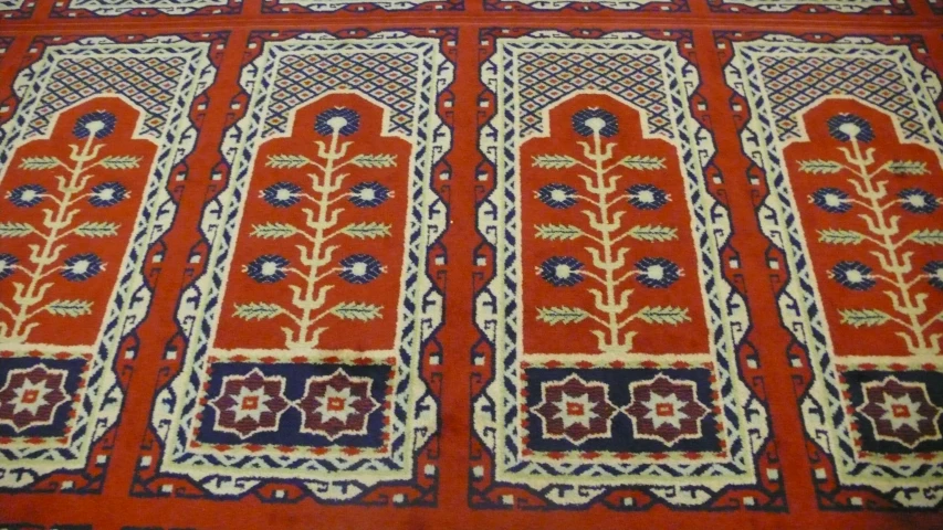 carpet with geometric designs and flowers is on display