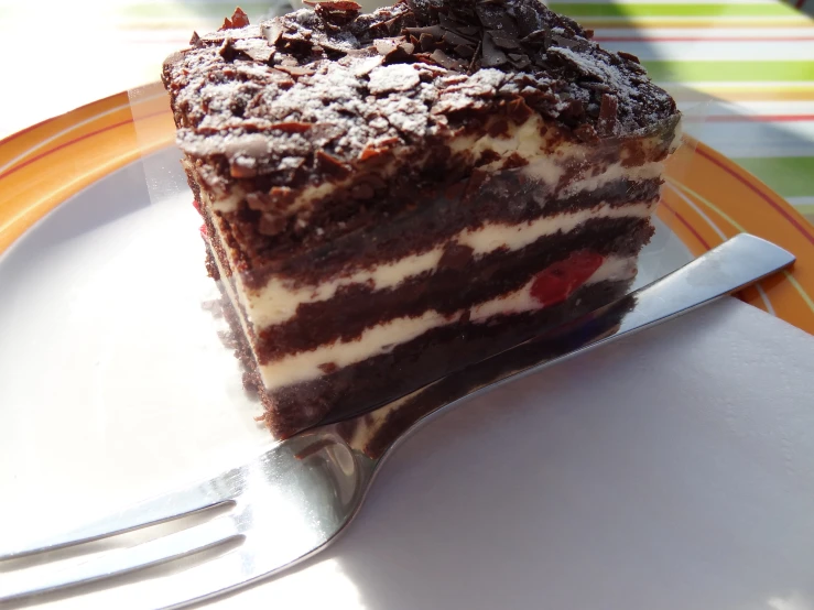 a slice of cake sitting on top of a white plate with a knife