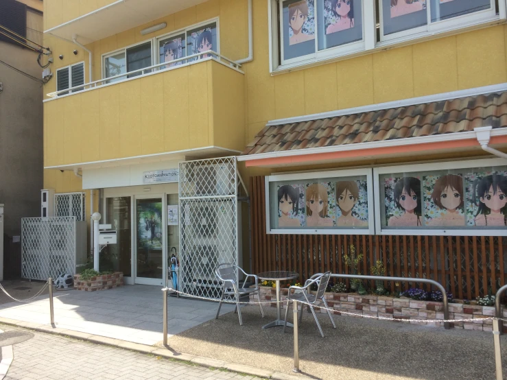 some anime pictures in front of a building