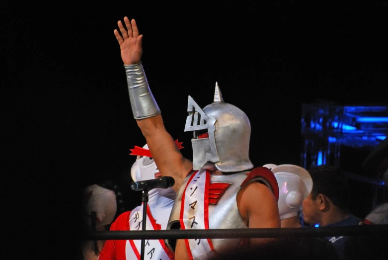 a man in an armor waving into the air