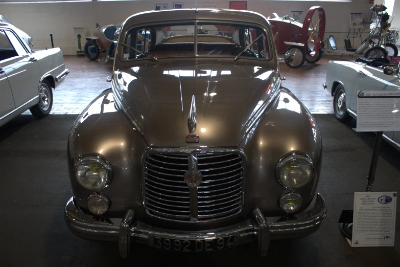 a car on display with other cars in the background