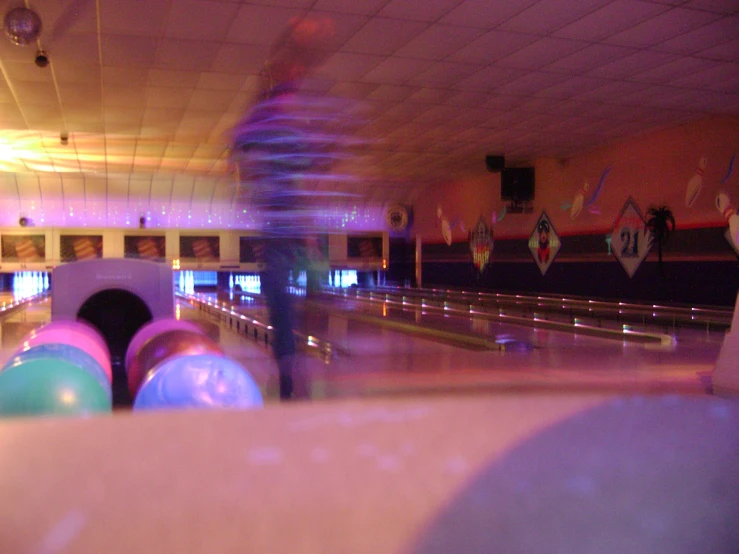 blurry po of bowling alleys with bowling balls