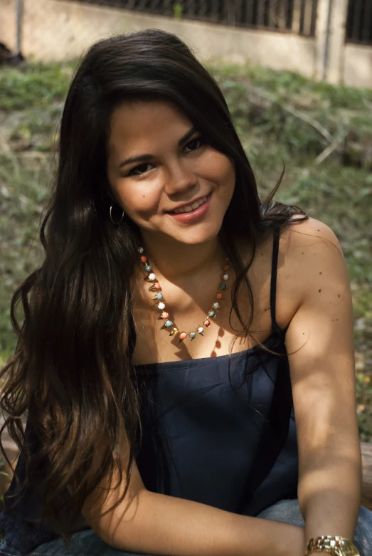 an adorable young woman wearing a beaded necklace