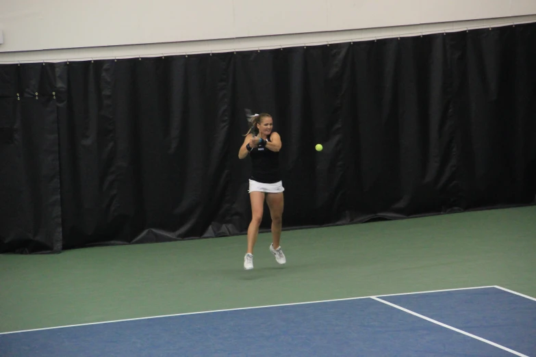 a woman is holding her tennis racket and playing tennis