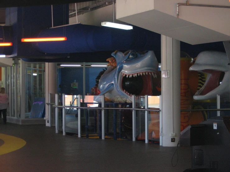 the entrance to a museum shows a sculpture of a large t - bone and dinosaur head