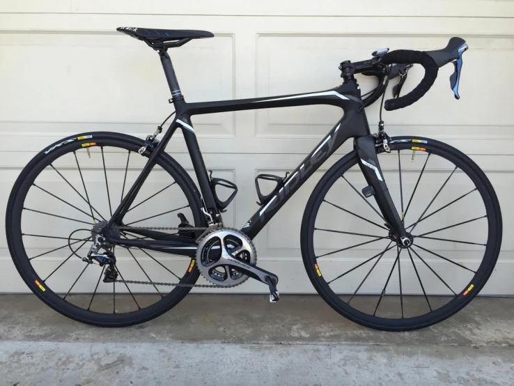 a bike parked in front of a white garage door