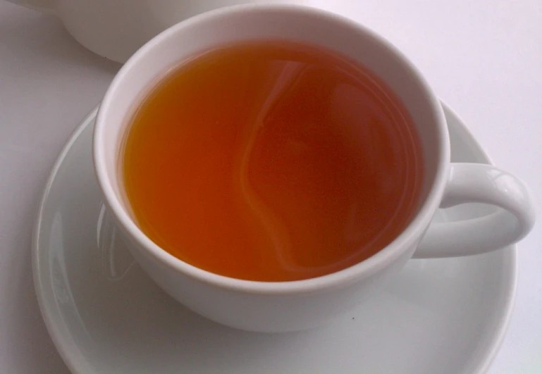 a cup of tea sitting on top of a plate