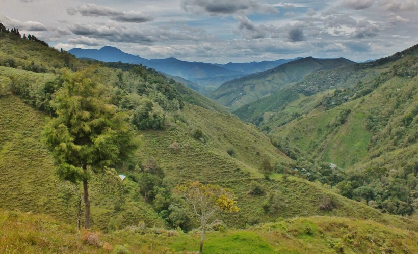 a very wide mountain valley that is in the middle of some hills