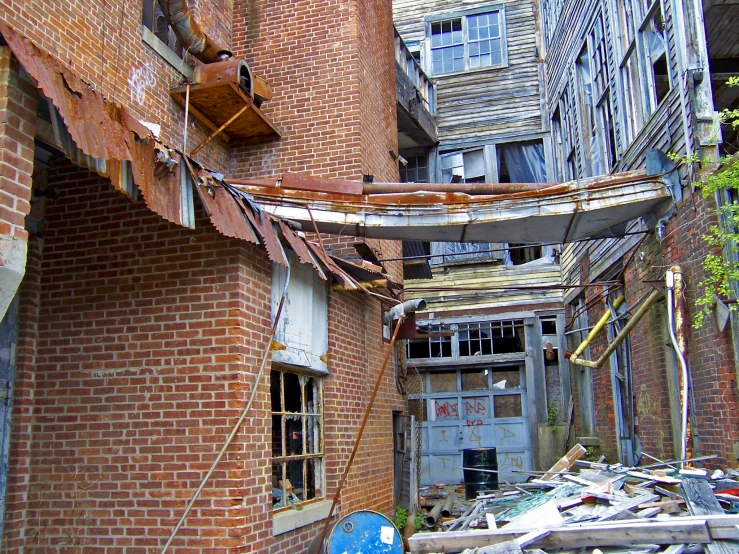 an alleyway with old construction and trash everywhere