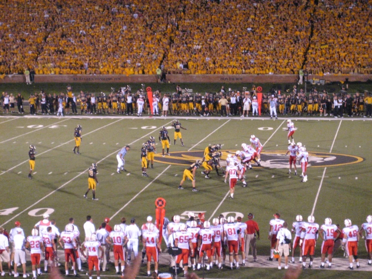 a group of football players and fans in stadium