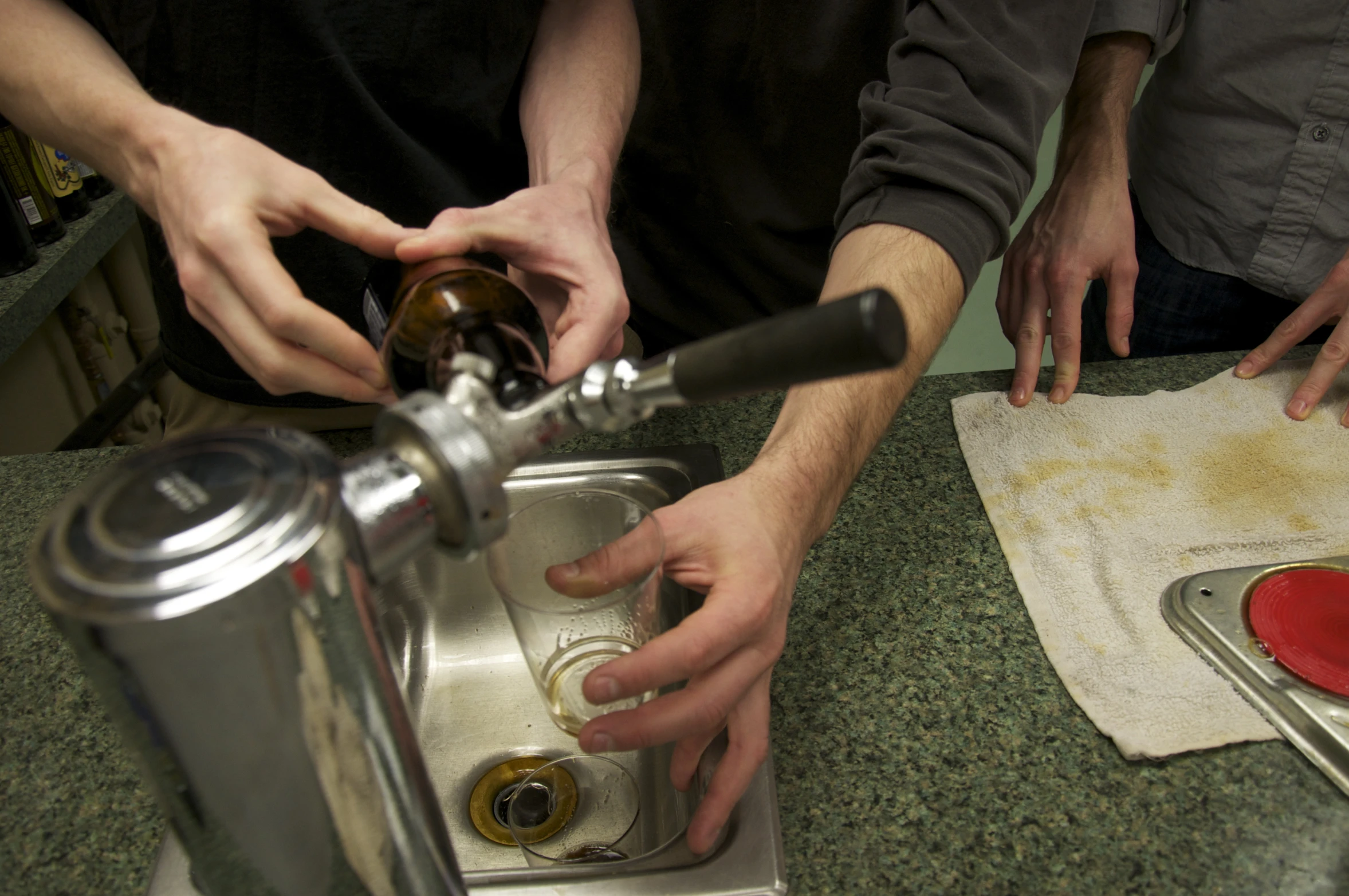 a group of people washing dishes in a sink