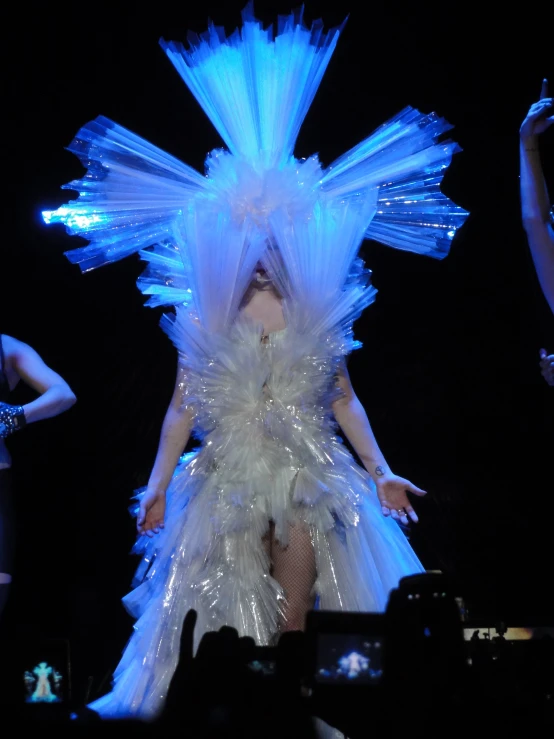 the woman is dressed in all white and dancing