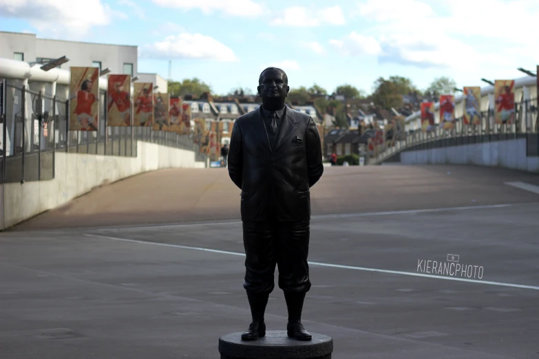 a statue is set in a park surrounded by spectators