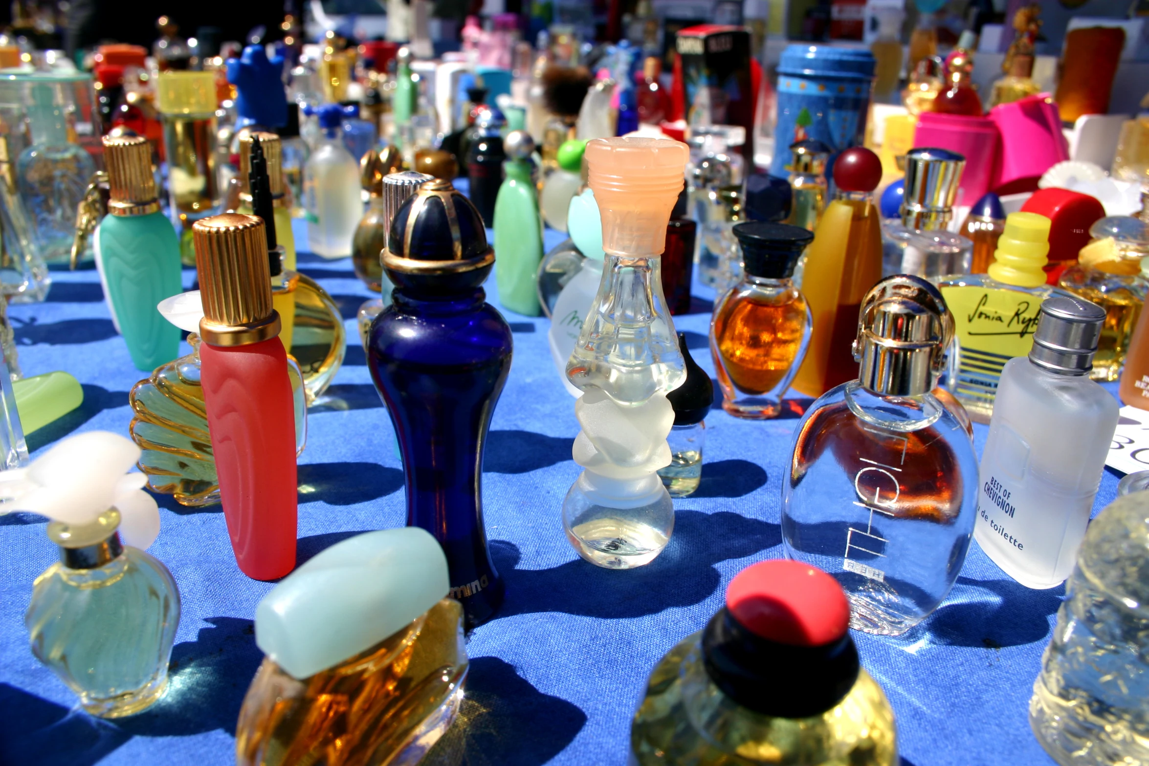 there are many different colored bottles that are on the table