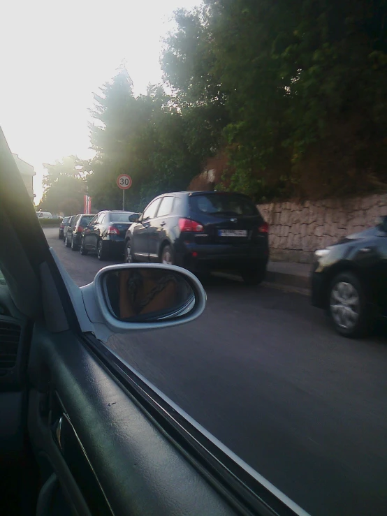 a view of a street with cars parked on both sides of it