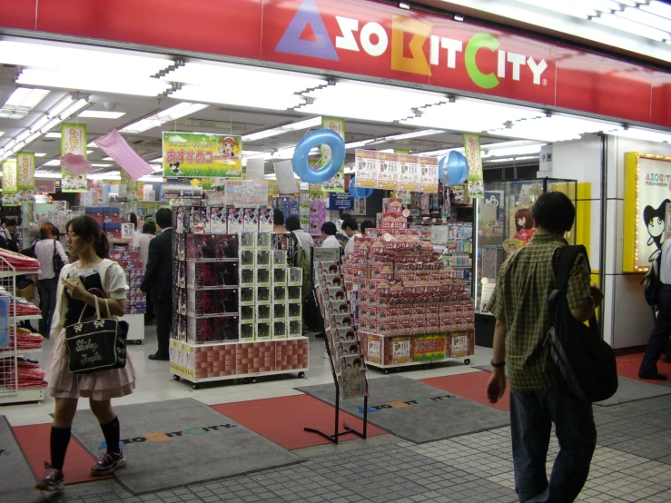 people walking through a store that has its products in display