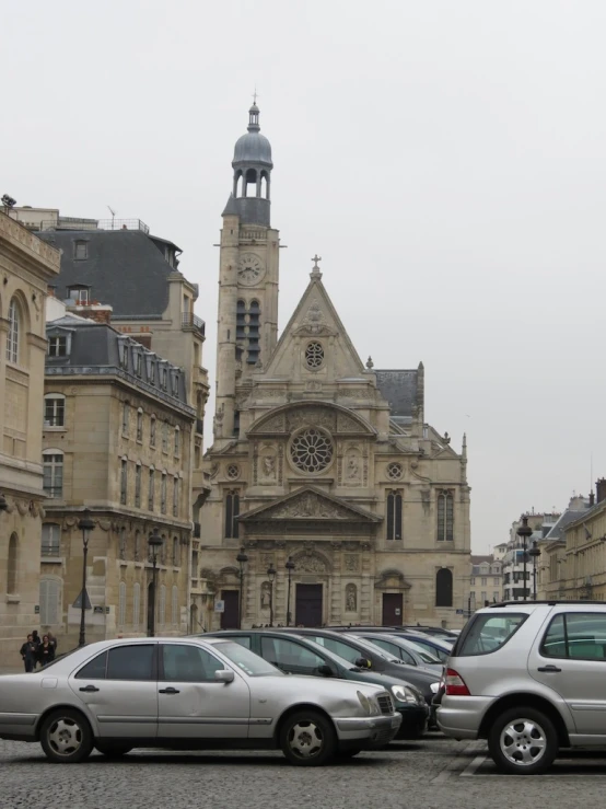 three cars parked in front of a church