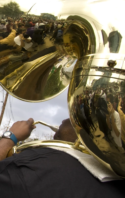 a band member plays a trombone in front of the crowd