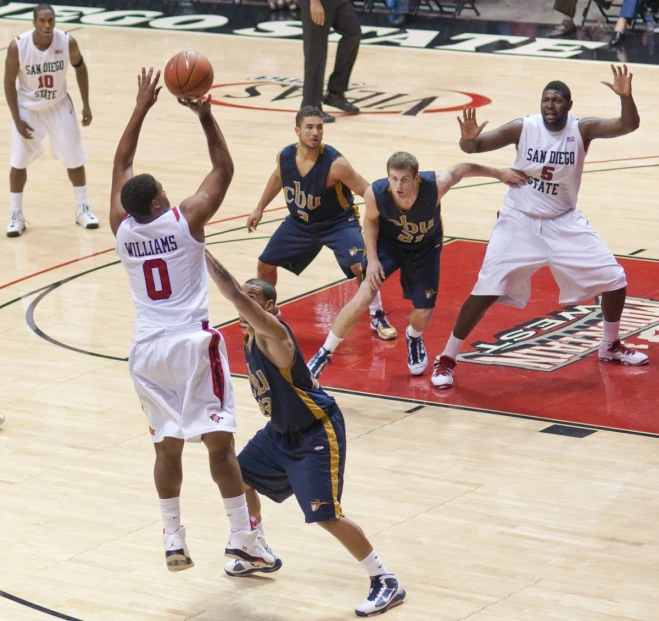 there are players playing basketball on a court