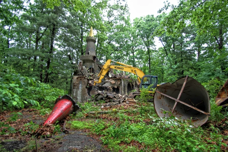 a forest area with an old tree stump and tractor in it
