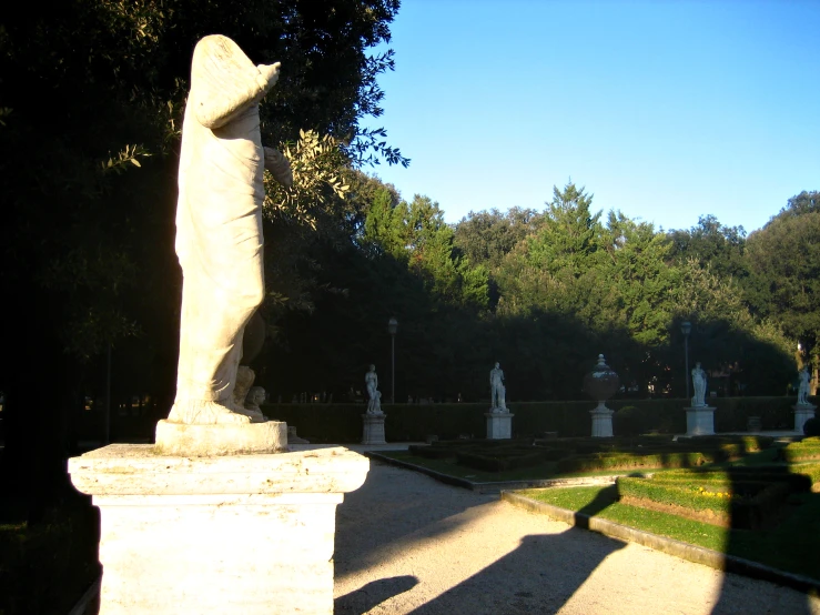 a shadow of a person walking in front of an ornate statue