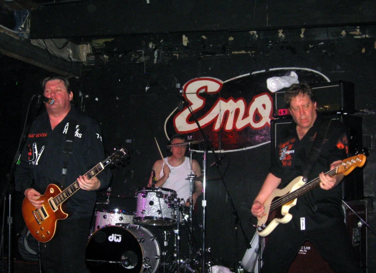 a band on stage at a show with their guitars