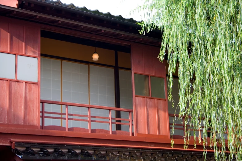 a wooden house with red sidings and window