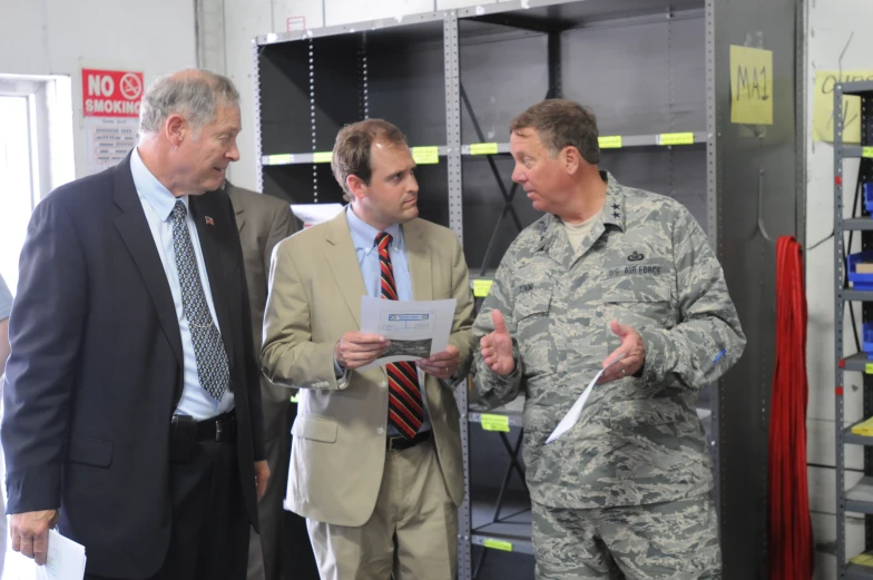 three men in uniform discussing with each other