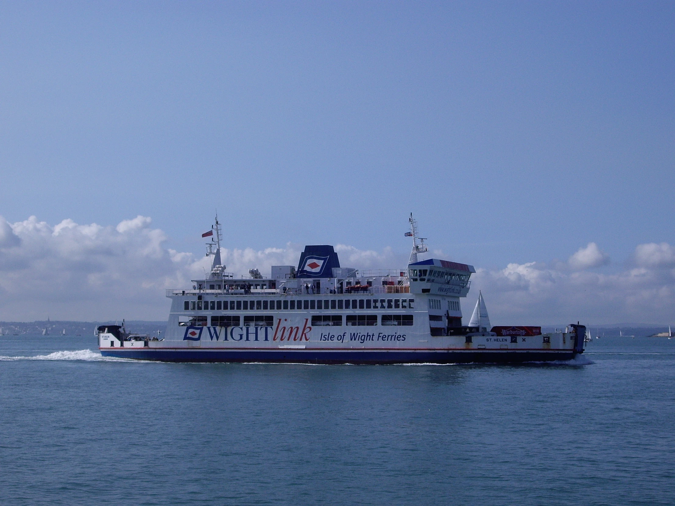 a large ferry in the ocean on a clear day