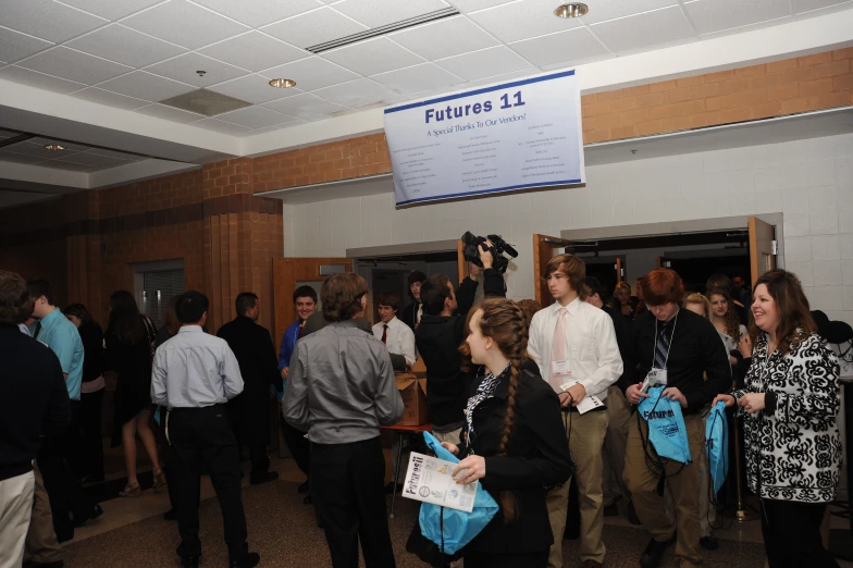 a large group of people standing next to each other in a room