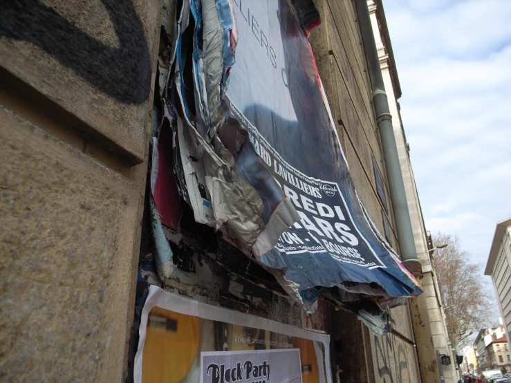 an upside down banner is on the side of a building