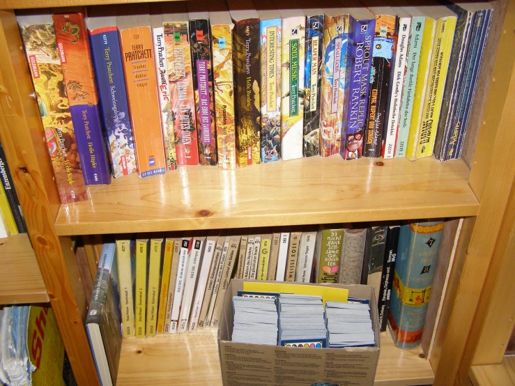 a book shelf filled with books and an envelope