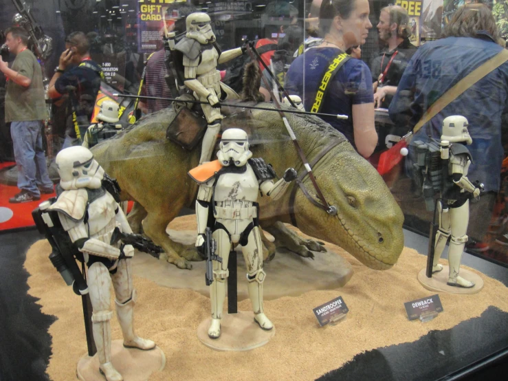 some storm trooper figures on display in a building